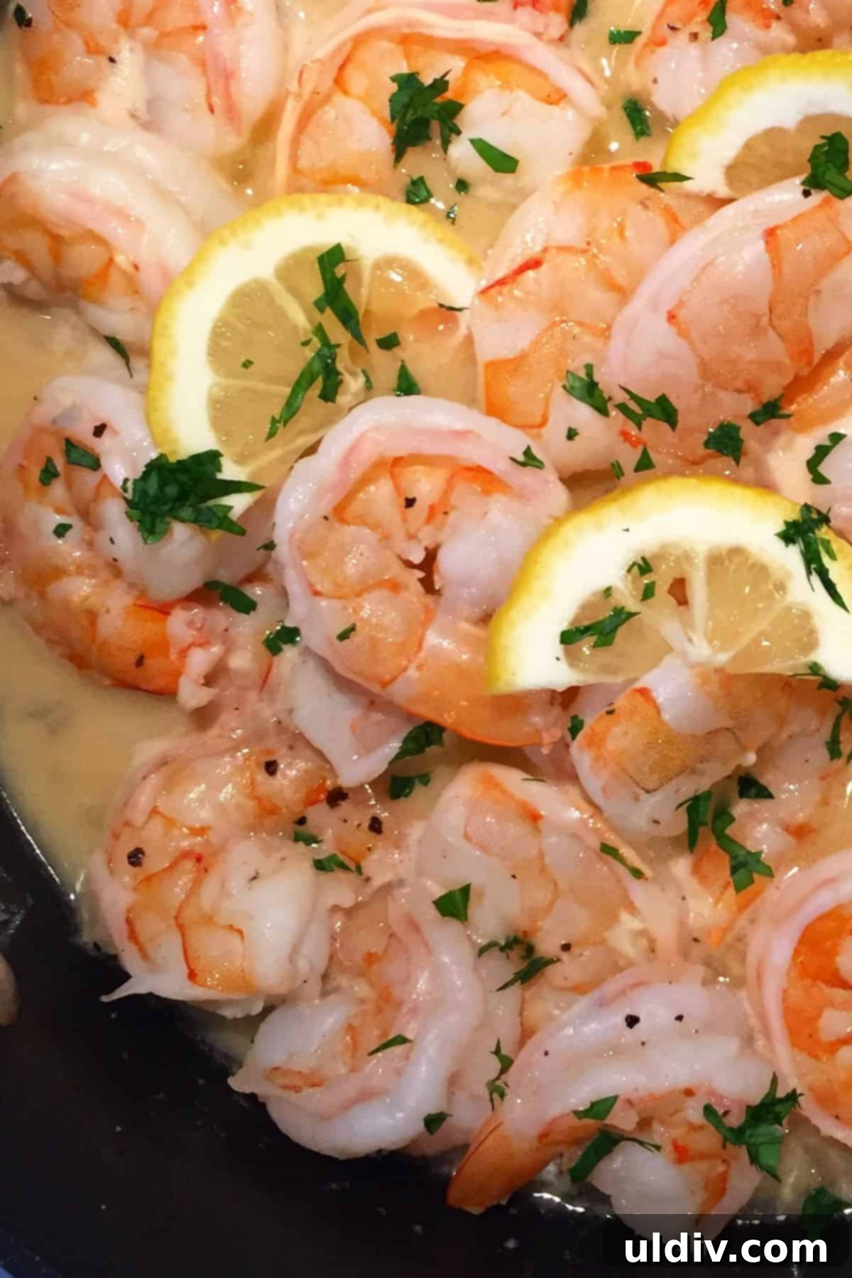 Zesty Garlic Butter Shrimp Scampi 4 Close-up of plump shrimp bathed in a glistening garlic butter and lemon wine sauce, garnished with fresh parsley.