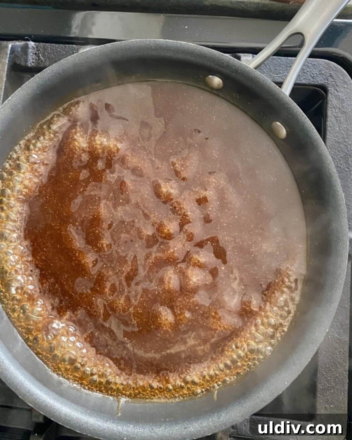 Glazed Teriyaki Salmon 7 Teriyaki sauce simmering and boiling in a small pot on the stove.