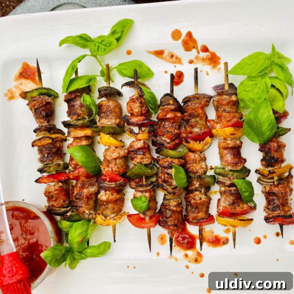 Flavorful Italian meat and veggie skewers arranged artfully, showcasing vibrant colors.