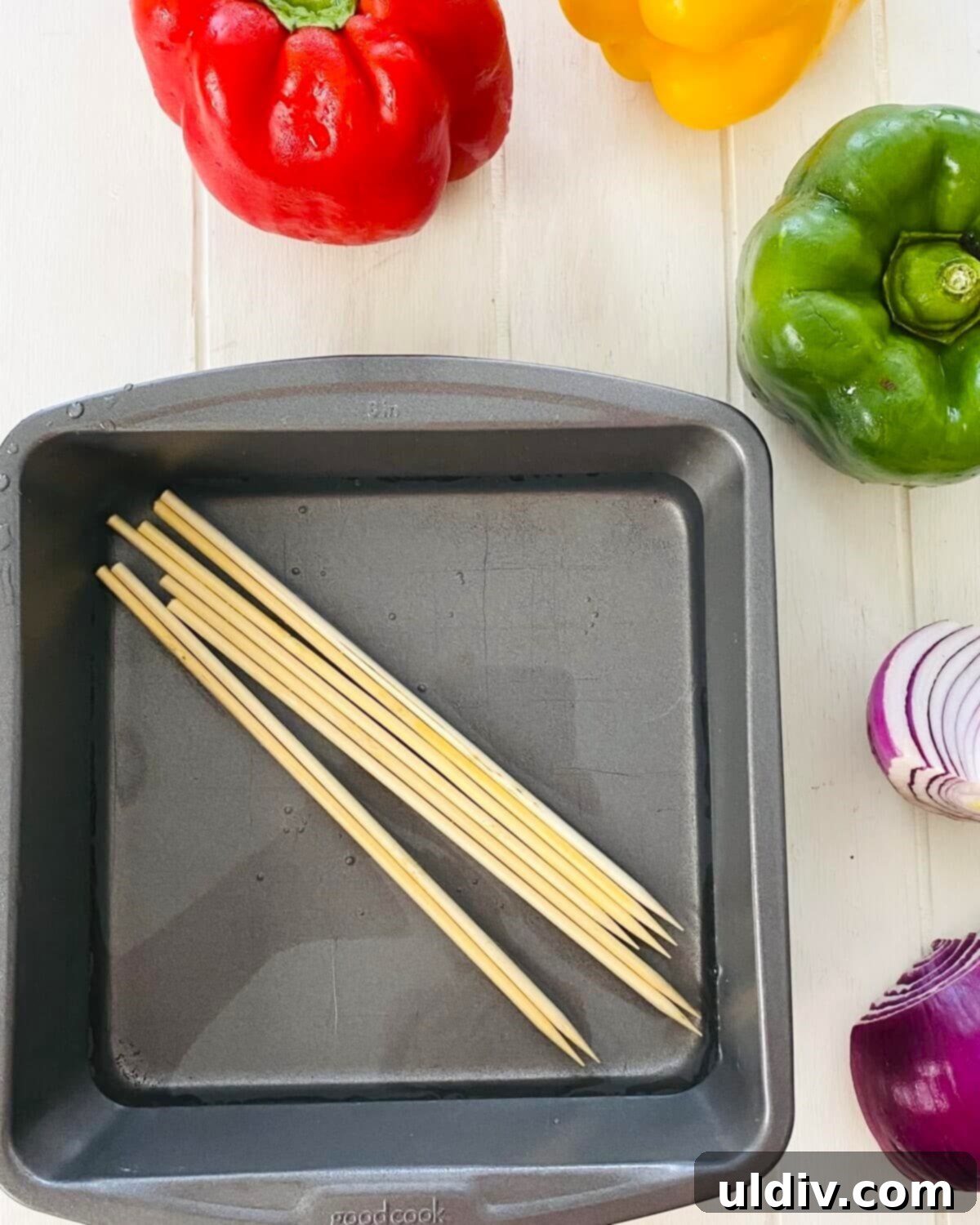 Grilled Italian Sausage & Veggie Skewers 4 A pan of water with wooden skewers soaking in it.