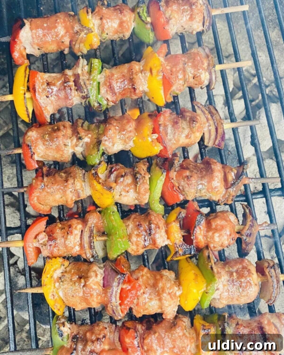 Perfectly grilled Italian sausage kabobs displayed on a Weber grill, ready to be served.