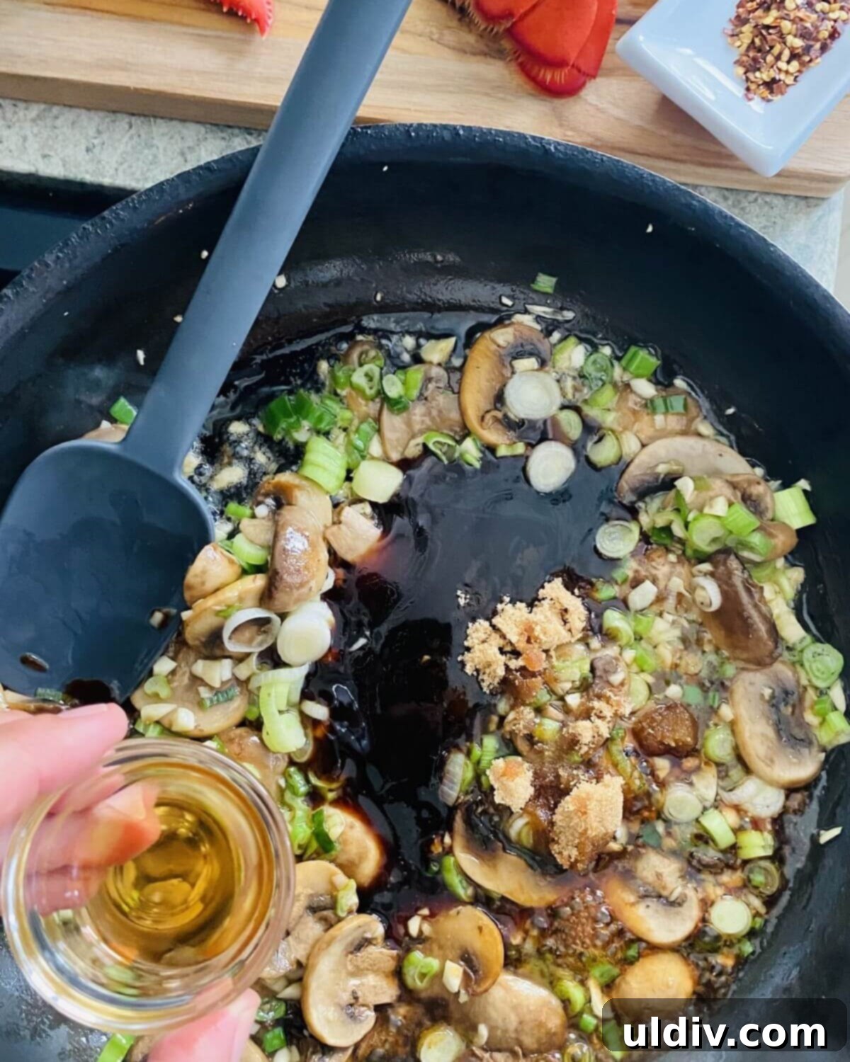 Decadent Garlic Lobster Noodles 8 adding, oyster sauce, sesame oil, brown sugar, and red pepper flakes to stir fry.