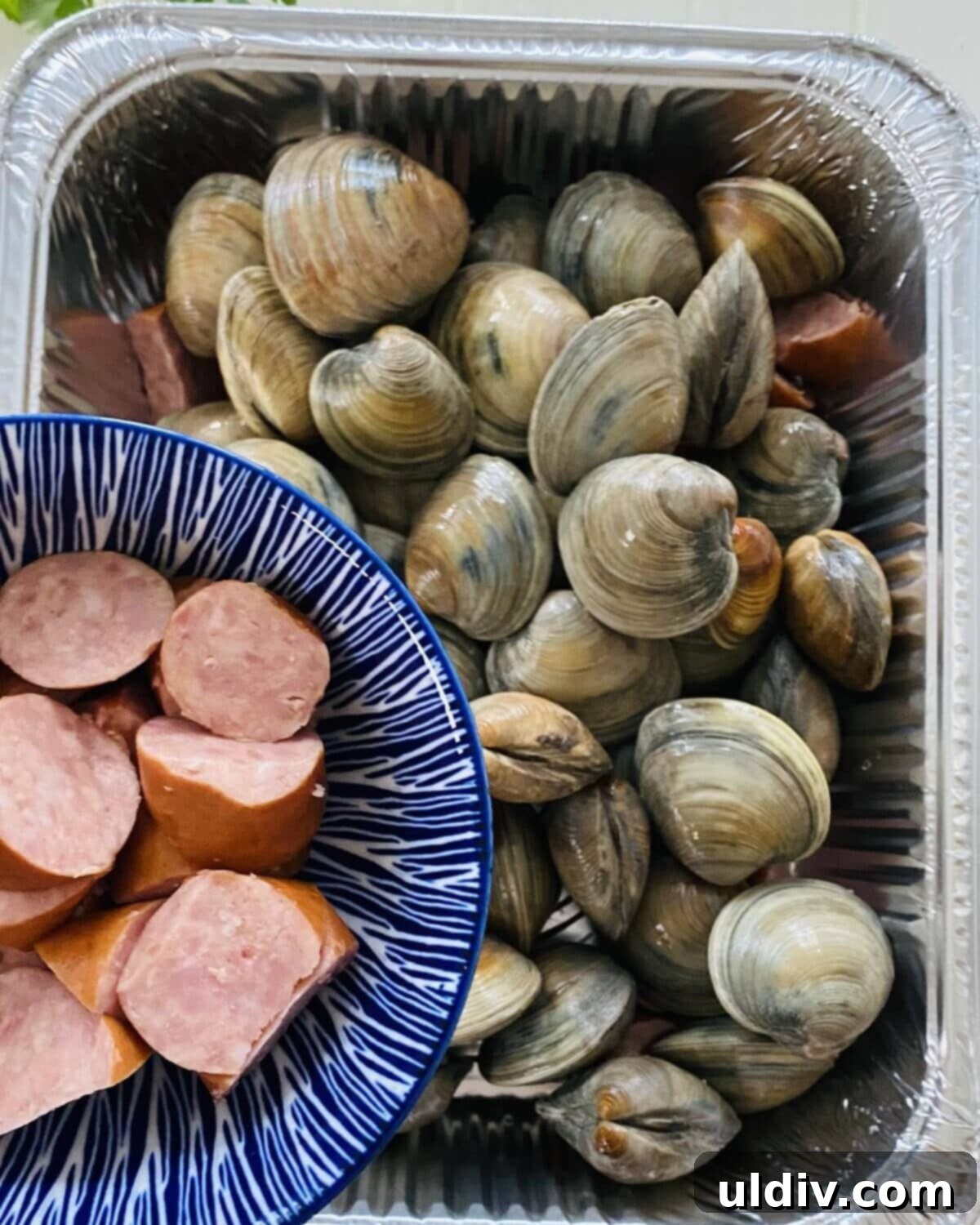 Rustic Drunken Clams with Kielbasa and Garlic 6 Littleneck clams layered with slices of kielbasa sausage.