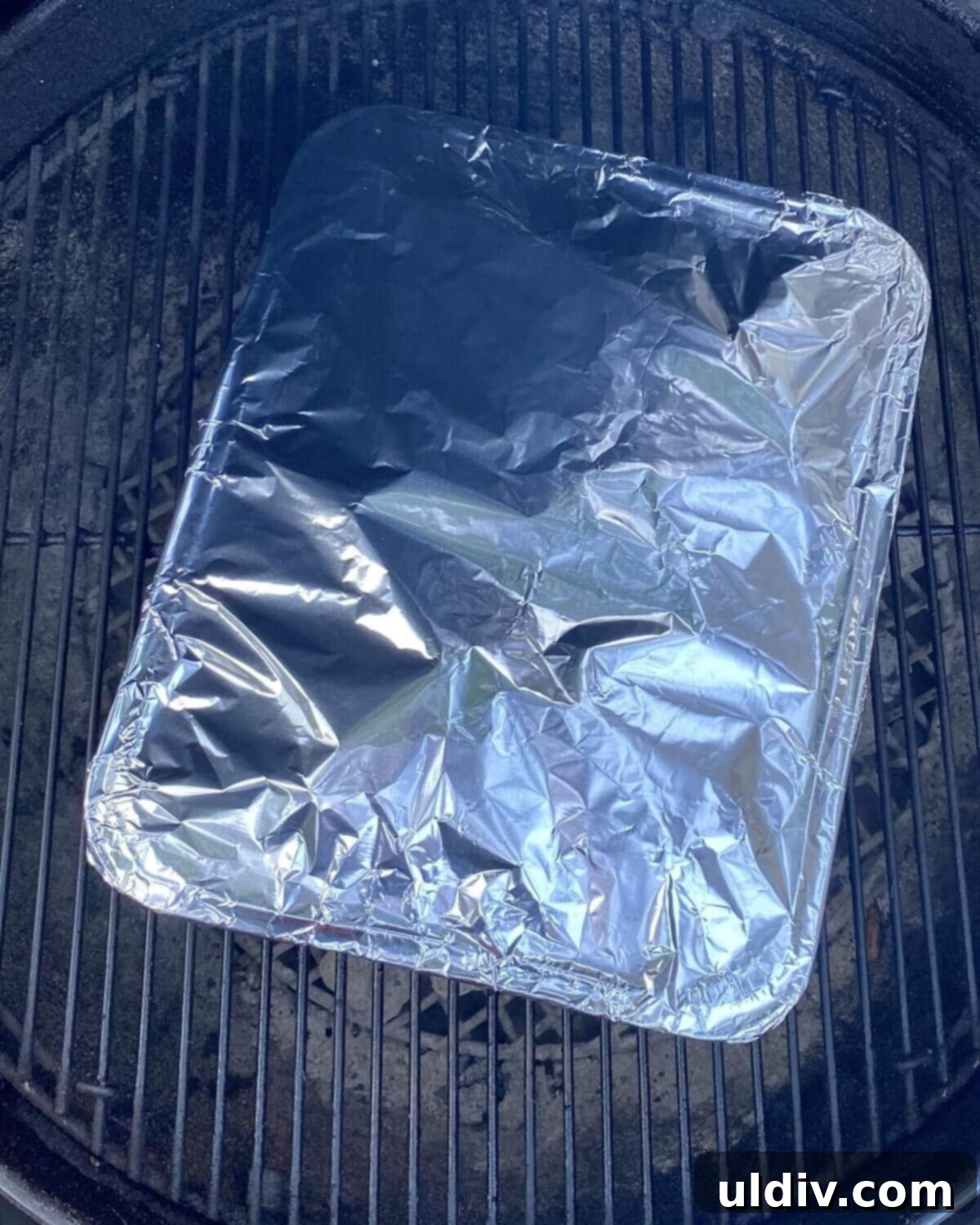 Rustic Drunken Clams with Kielbasa and Garlic 8 Covered foil pan placed on a hot grill.