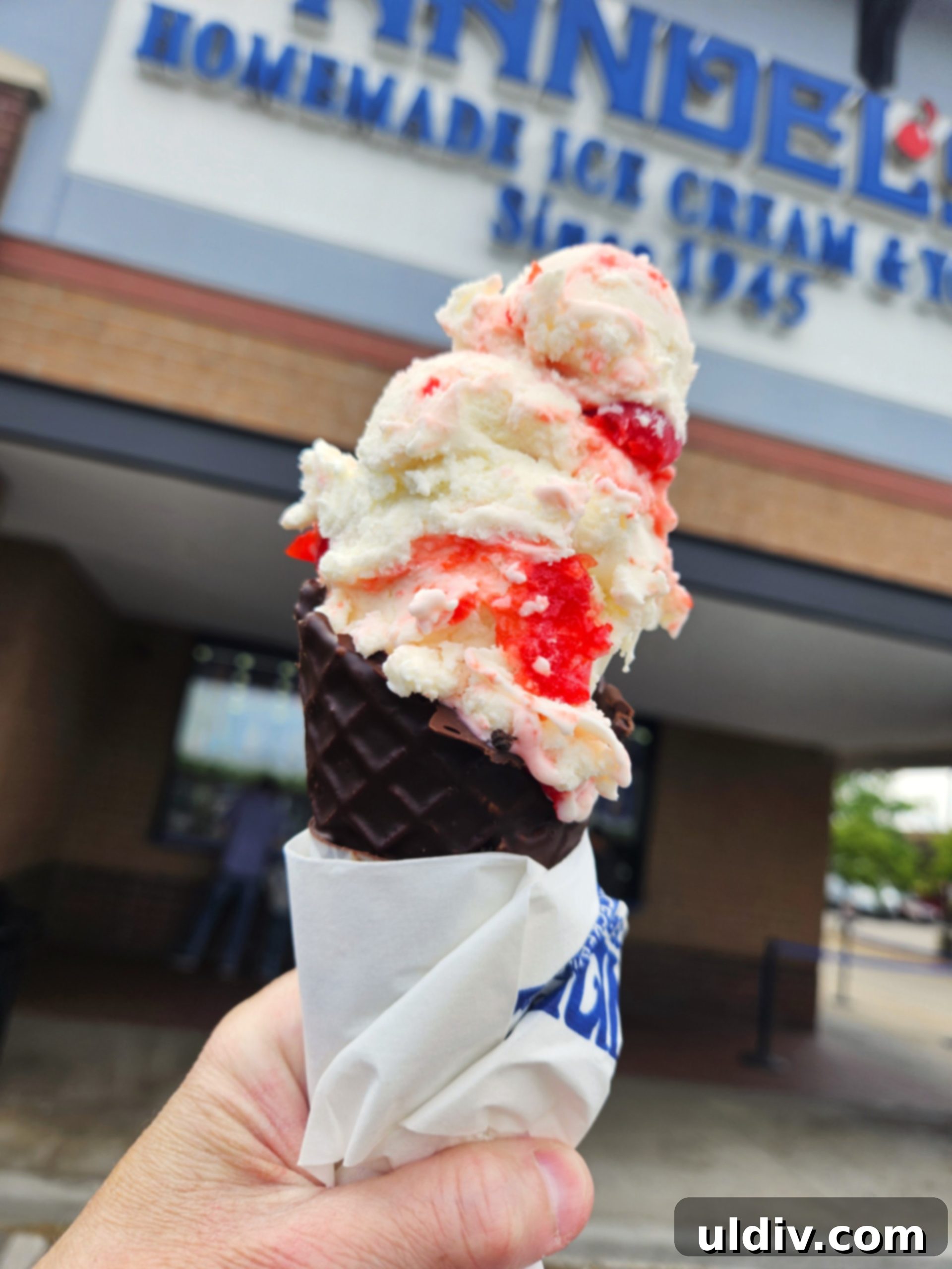Handel's Ice Cream: Summer's Sweetest Stop 2 A vibrant scoop of Handel's homemade ice cream in a waffle cone, inviting delight.