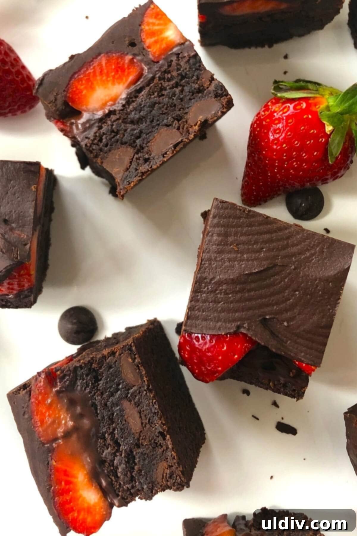 Fudgy Chocolate-Dipped Brownies with Fresh Strawberries 12 A close-up of a single, perfectly cut chocolate strawberry brownie on a white plate, highlighting its rich layers and tempting texture.