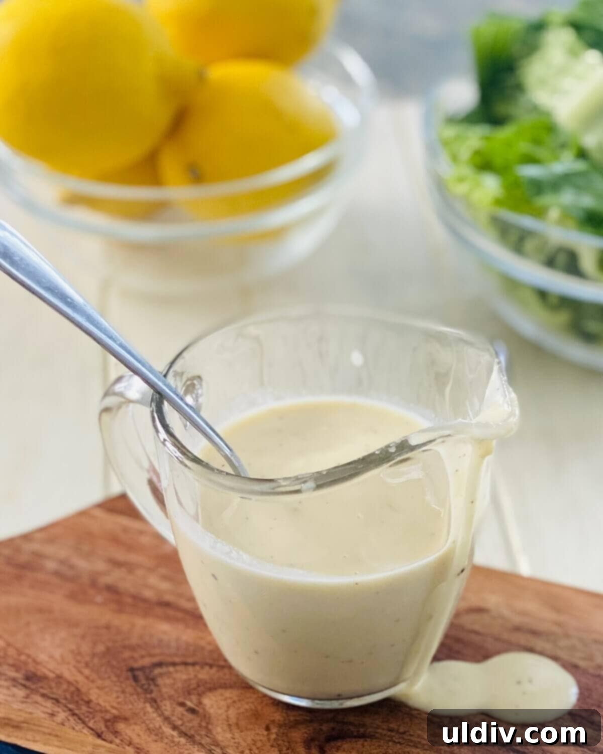 Homemade Caesar Dressing No Anchovies 8 a pitcher of Caesar salad dressing without anchovies.