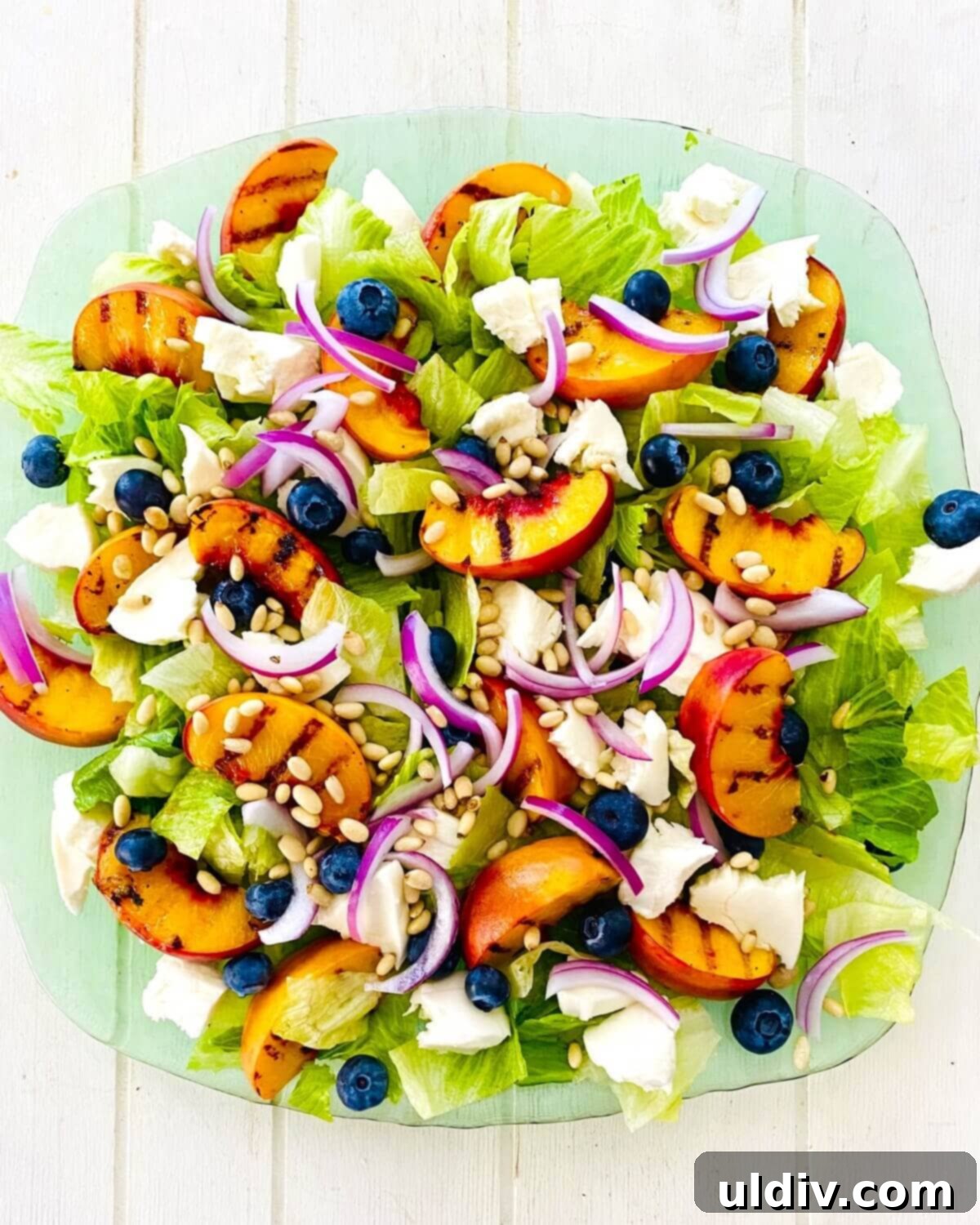 Sweet and Savory Grilled Peach Mozzarella Salad 6 A grilled peach salad on a platter.