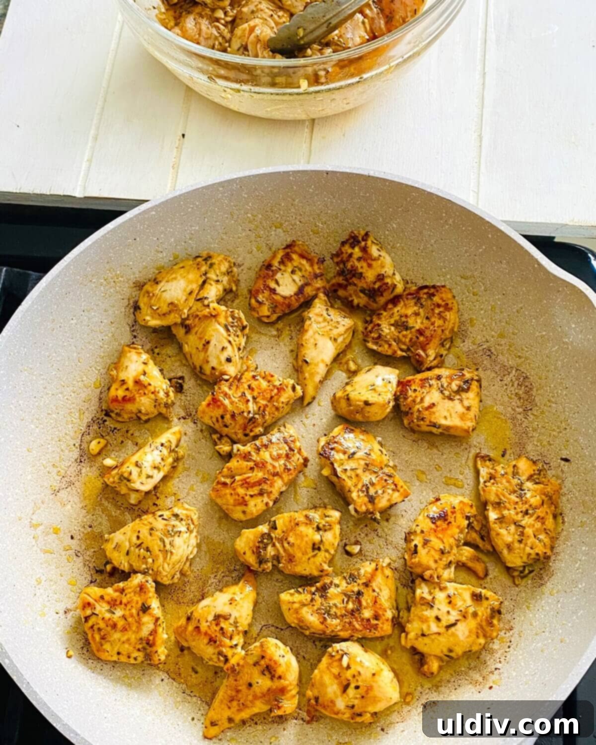 Zesty Italian Herb Chicken with Creamy Caesar Dip 7 sautéing chicken in a pan.