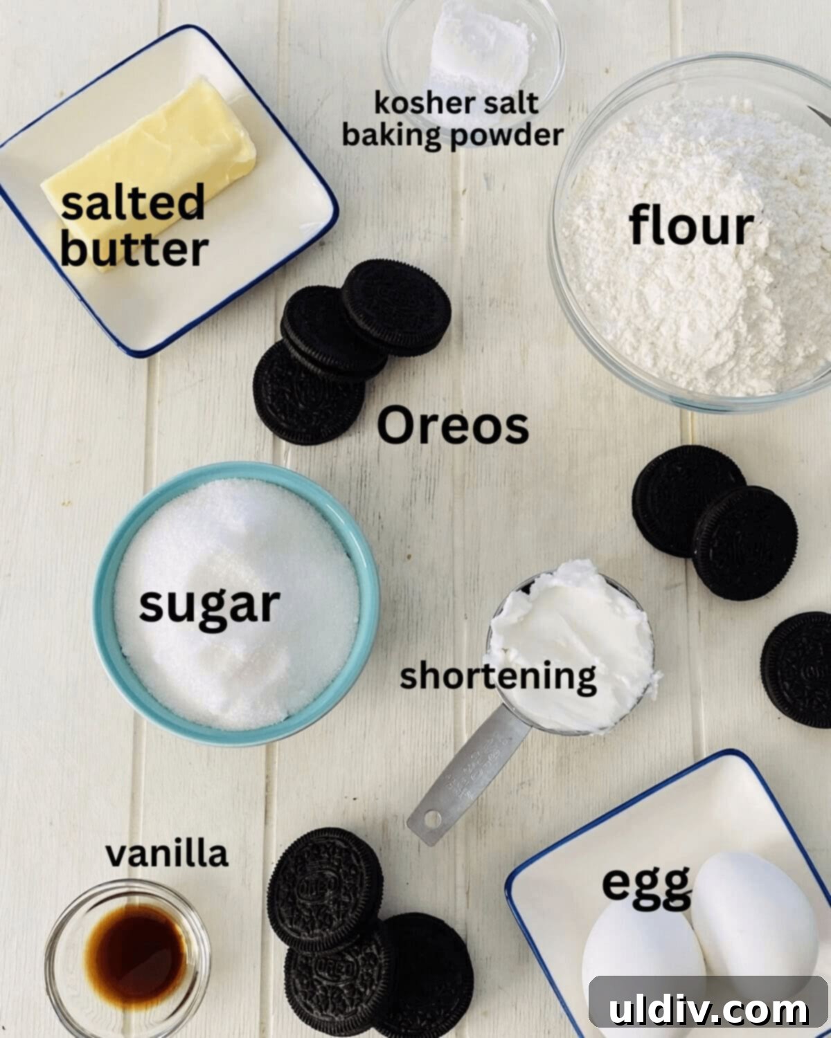 Perfectly Shaped Oreo Sugar Cookies 3 A curated display of ingredients including flour, sugar, Oreos, butter, shortening, and vanilla extract, ready for baking.