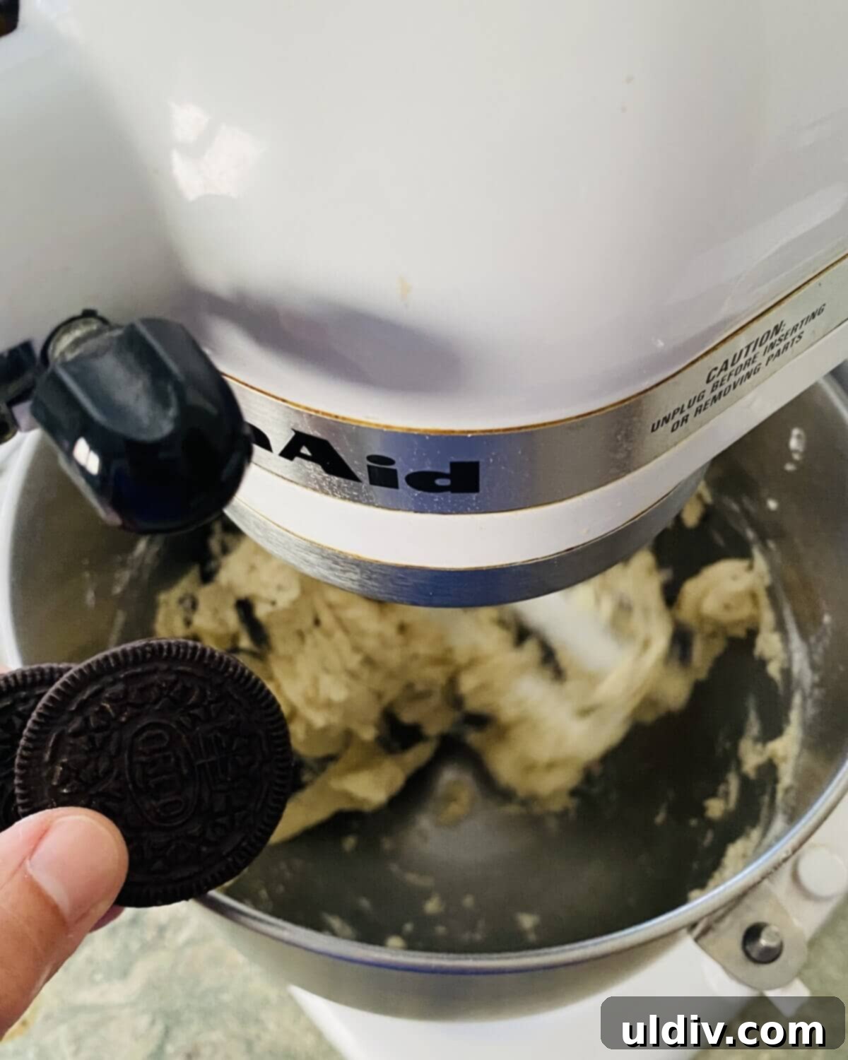 Perfectly Shaped Oreo Sugar Cookies 6 Whole Oreo cookies being added to sugar cookie batter in a mixer, ready to be broken into pieces.