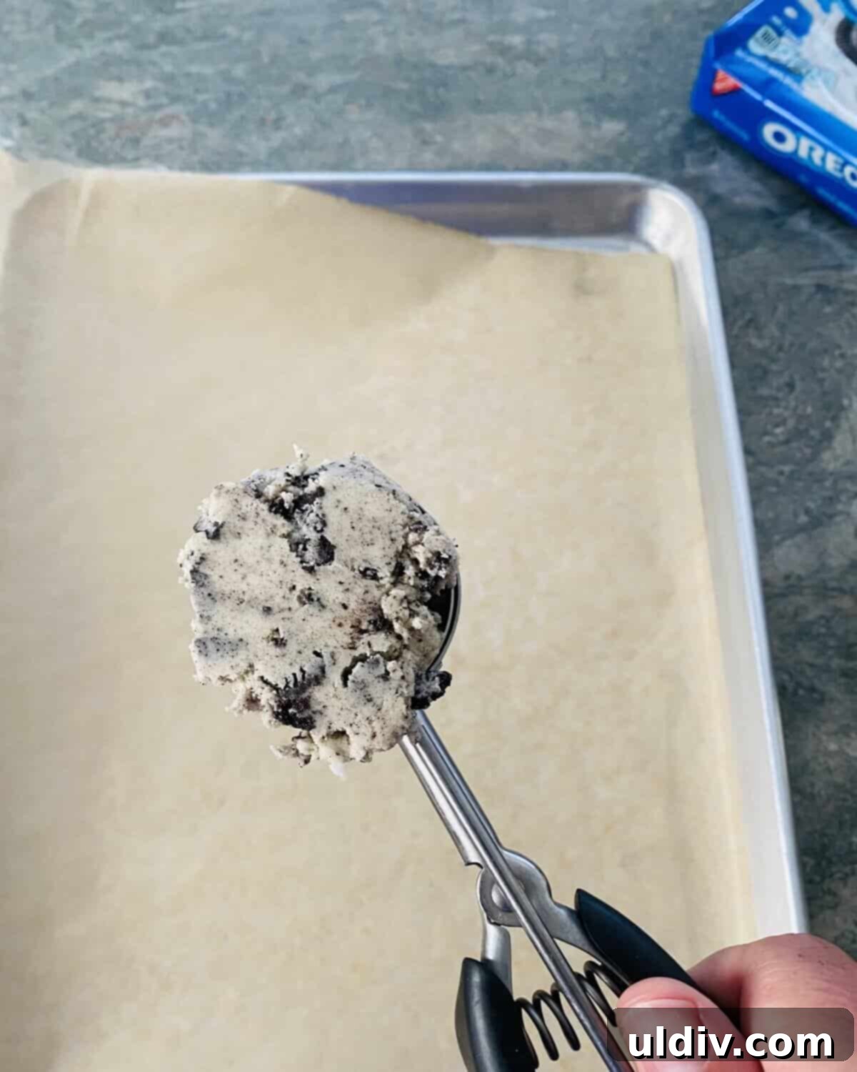 Perfectly Shaped Oreo Sugar Cookies 7 A cookie scoop filled with perfect sugar cookie dough, ready for placement on a baking sheet.