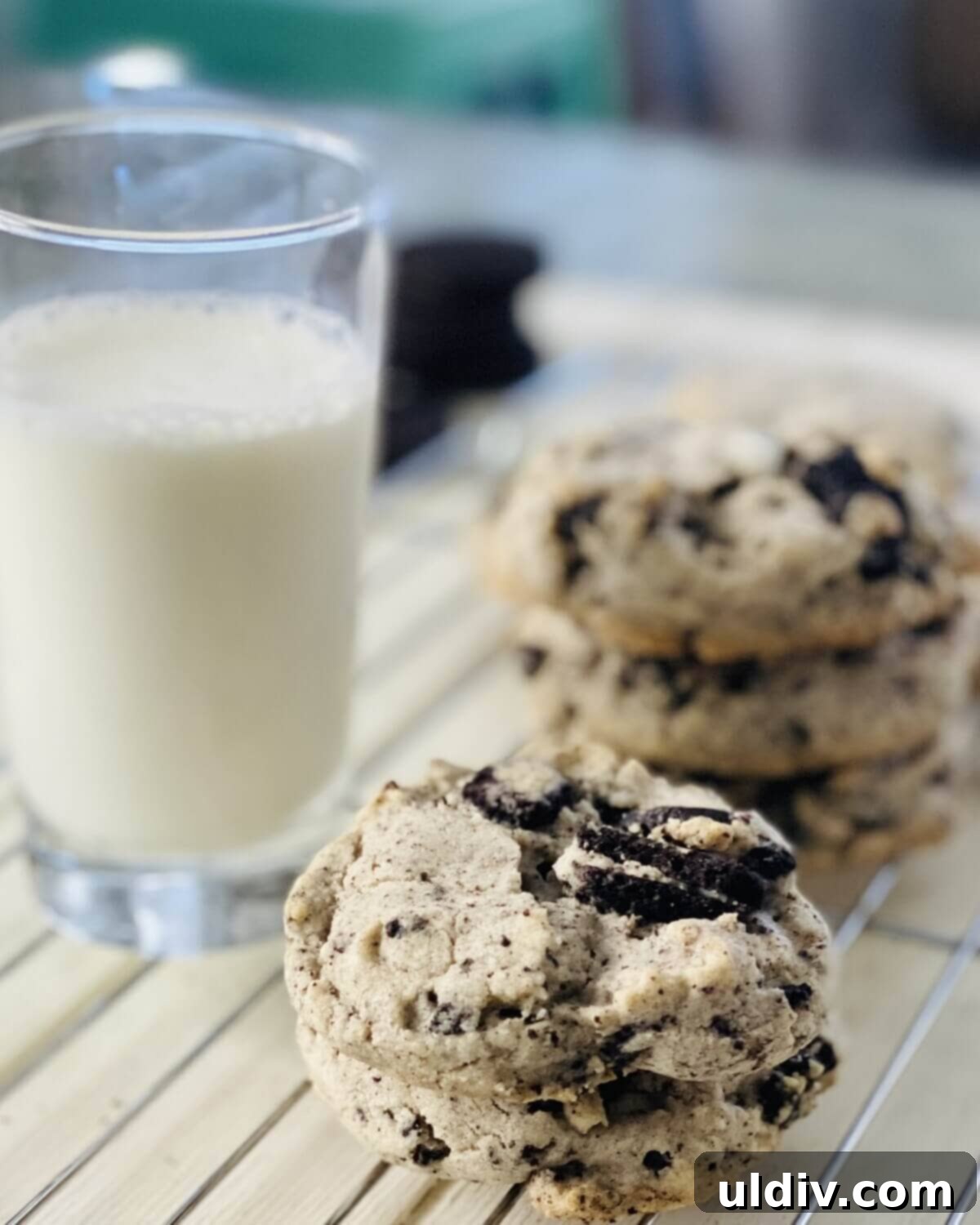 Perfectly Shaped Oreo Sugar Cookies 10 A refreshing glass of milk beside a stack of freshly baked Oreo sugar cookies, ready for dunking.