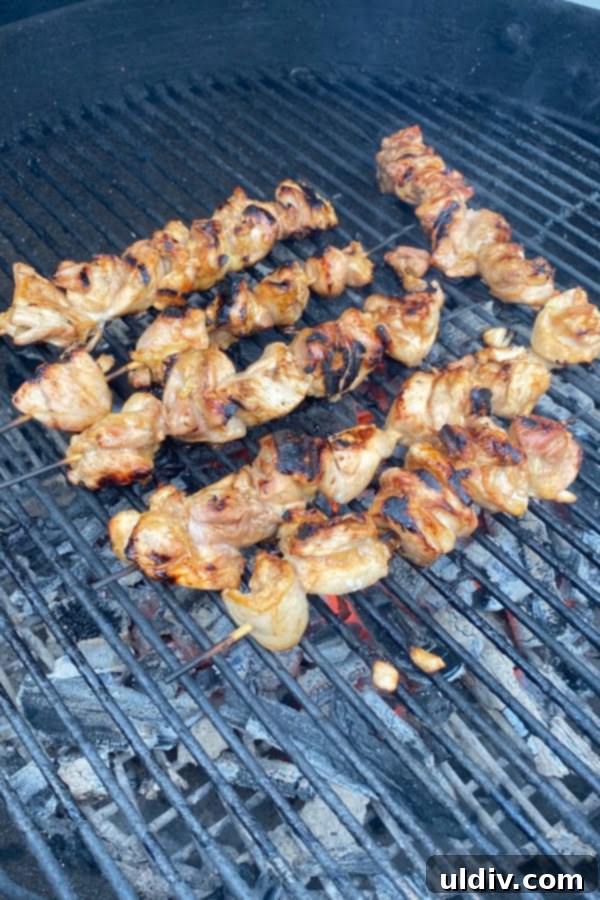 Zesty Balsamic Steak Marinade 4 Succulent marinated chicken skewers grilling perfectly over glowing charcoal on a grill, promising a smoky and tender meal.