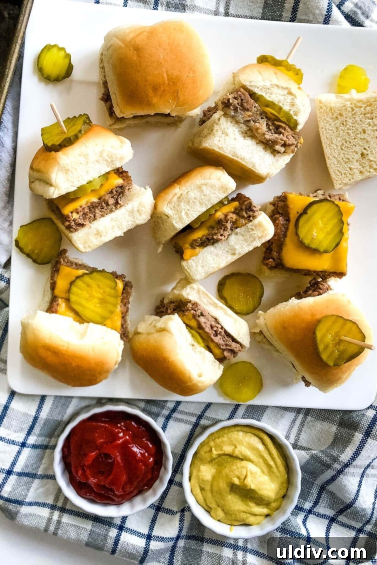Crowd-Pleasing Cheeseburger Sliders 12 Cheeseburger sliders arranged neatly on a platter, ready to be served.