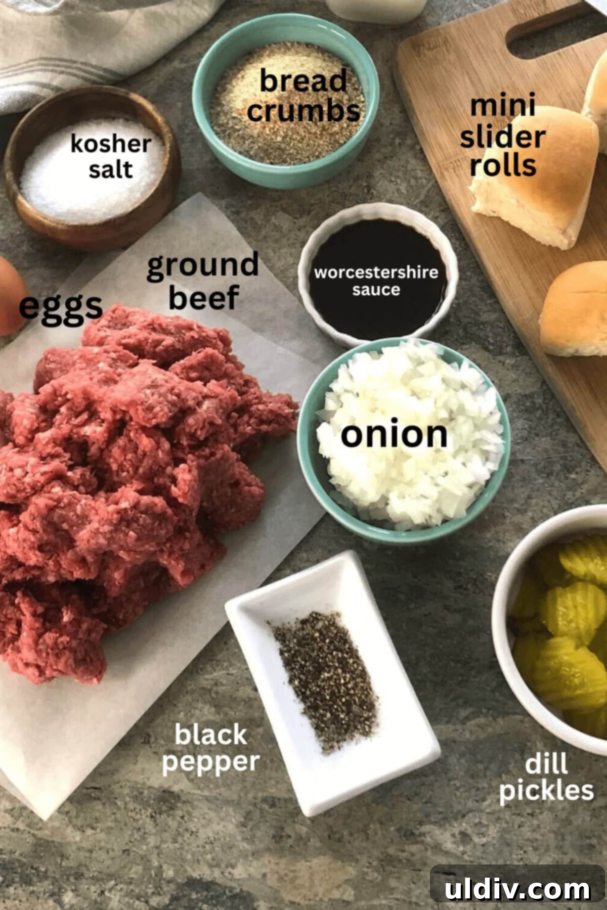 Crowd-Pleasing Cheeseburger Sliders 4 ingredients for sliders, including ground beef, onion, cheese, and buns.