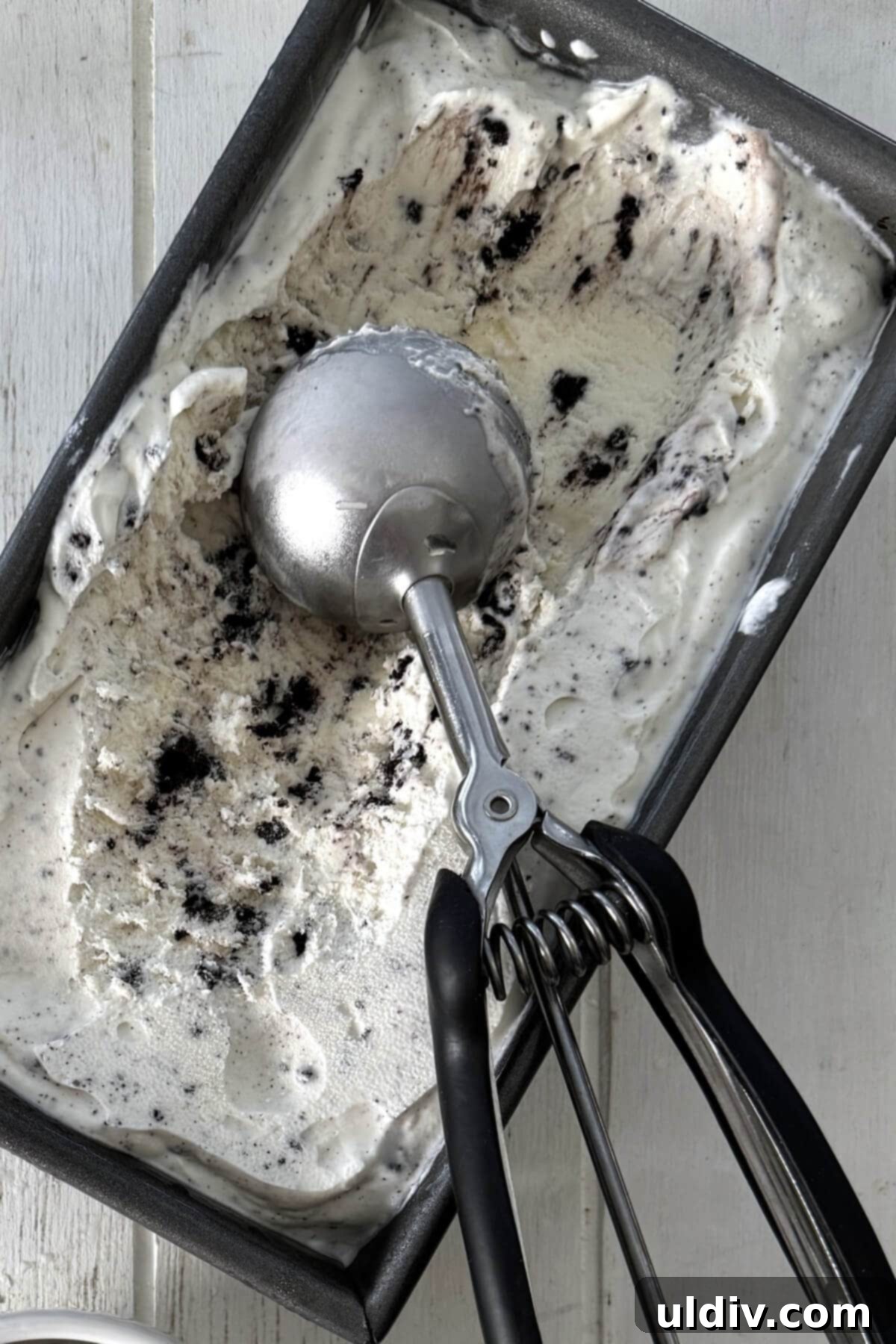Whip Up Homemade Ice Cream 4 A metal loaf pan filled with creamy no-churn ice cream, ready for scooping.