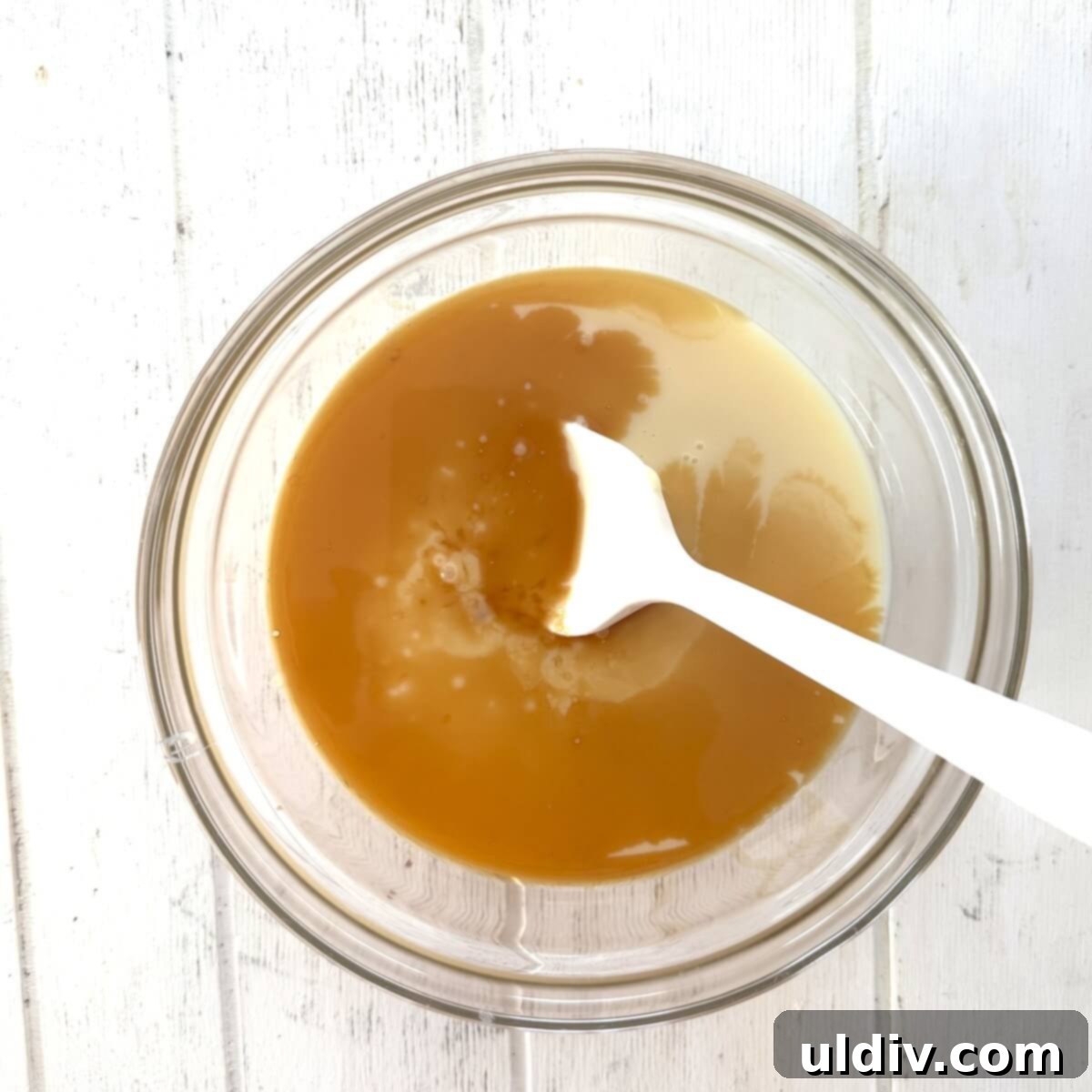 Sweetened condensed milk, vanilla, and kosher salt combined in a bowl.