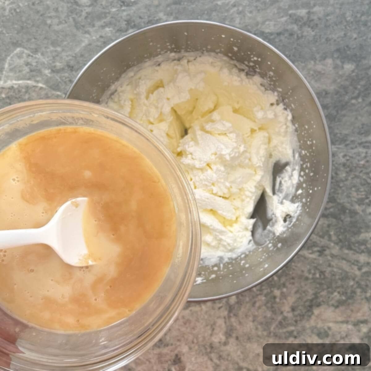 Gently adding the sweetened condensed milk mixture to the whipped cream.