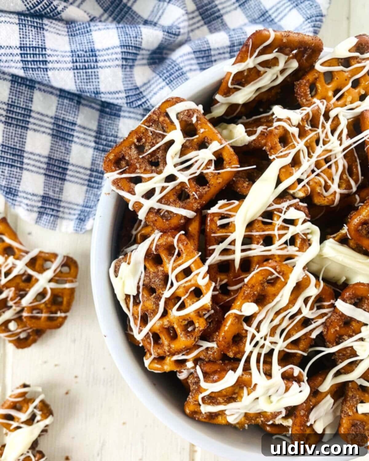 Creamy Pumpkin Pretzel Twists 2 Crunchy pumpkin spiced pretzels with a generous white chocolate drizzle, ready to be enjoyed as a sweet and salty fall snack.