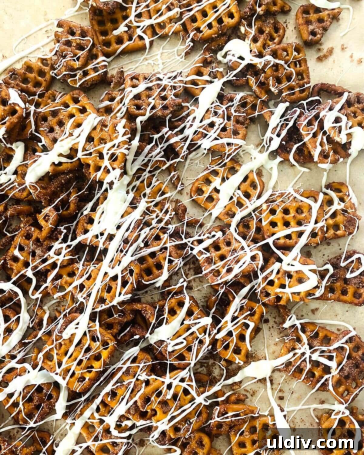 Creamy Pumpkin Pretzel Twists 9 Pumpkin spiced pretzels generously drizzled with white chocolate, hardening on a sheet.