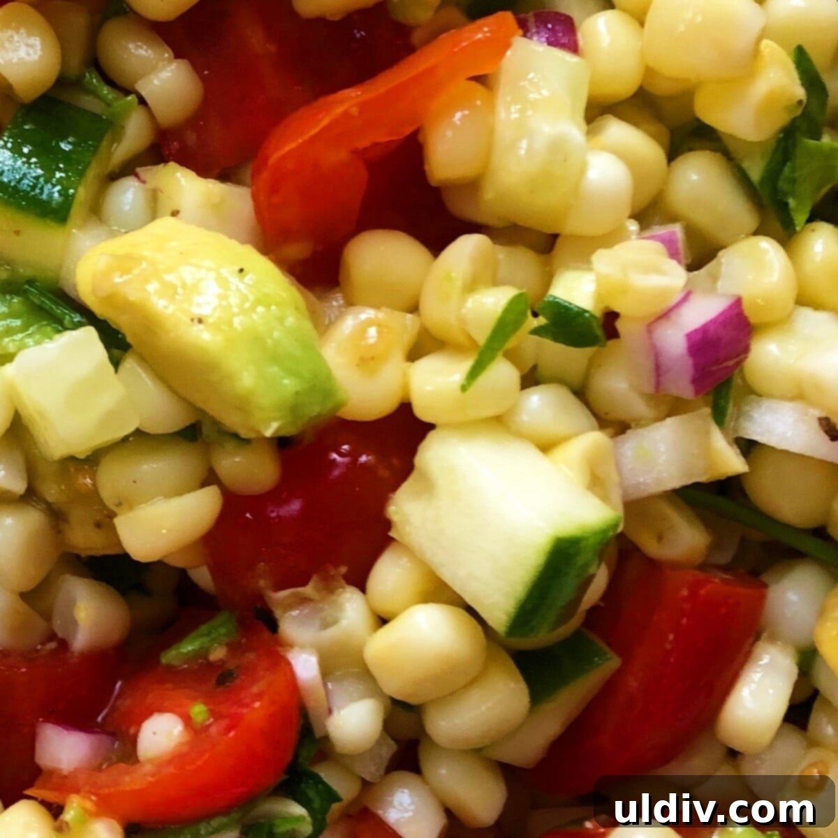 A Colorful Summer Medley of Avocado, Corn, Cucumber, and Tomato 3 Close-up of fresh corn, crisp cucumber, and juicy tomatoes, key ingredients for a vibrant summer salad.