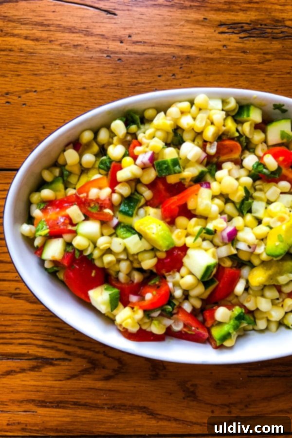 A Colorful Summer Medley of Avocado, Corn, Cucumber, and Tomato 5 A colorful side dish of summer produce, showcasing ripe tomatoes and crisp cucumbers, ready for a healthy meal.