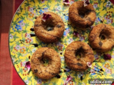 Beyond the Spoon: Creative Ways to Use Blackstrap Molasses 4 A selection of delicious baked pumpkin donuts, generously topped with blackstrap molasses, arranged artfully on a plate, ready to be enjoyed.
