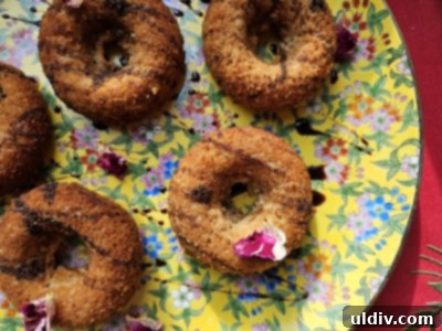 Beyond the Spoon: Creative Ways to Use Blackstrap Molasses 5 An overhead shot of baked pumpkin donuts, one delicately bitten into to reveal its soft, spiced interior, with a rich blackstrap molasses drizzle, perfect for a cozy fall treat.
