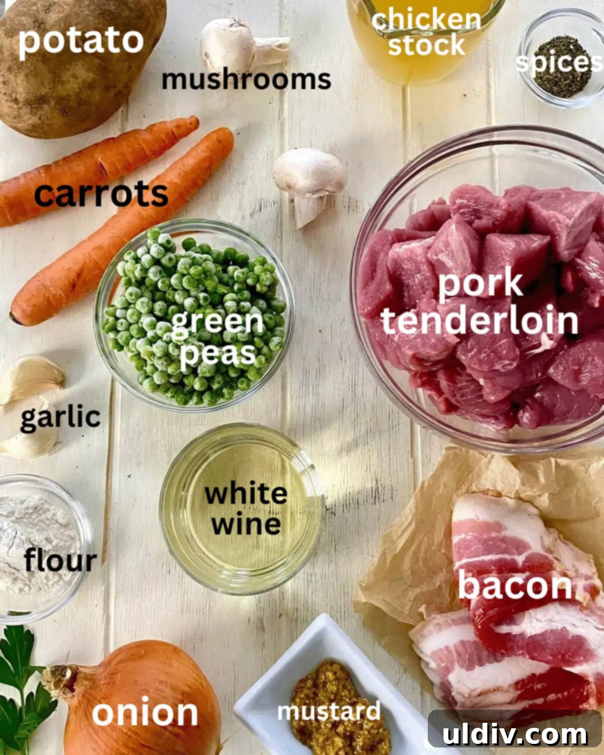 Hearty Pork Tenderloin and Bacon Stew 3 Various ingredients for pork tenderloin stew laid out: pork tenderloin cubes, flour, white wine, mushrooms, carrots, potato, garlic, bacon, onion, and spices.