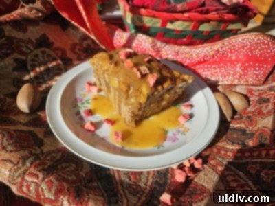 Edna Lewis's Signature Apple Cake 8 A close-up slice of Edna Lewis's apple cake, revealing its moist texture, apples, pecans, and caramel glaze