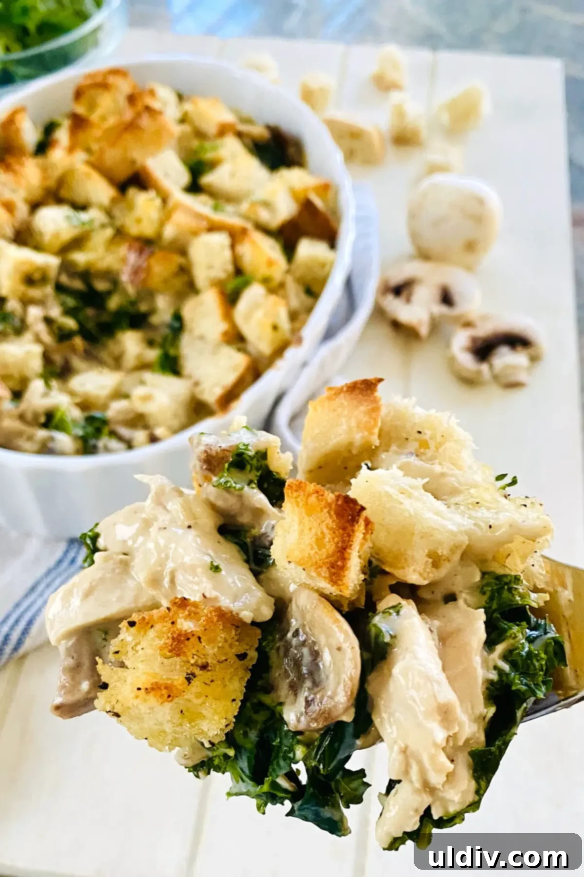 Comforting Creamy Chicken and Kale Casserole 13 A spoonful of Creamy Chicken and Kale Casserole, showcasing its rich texture and ingredients.