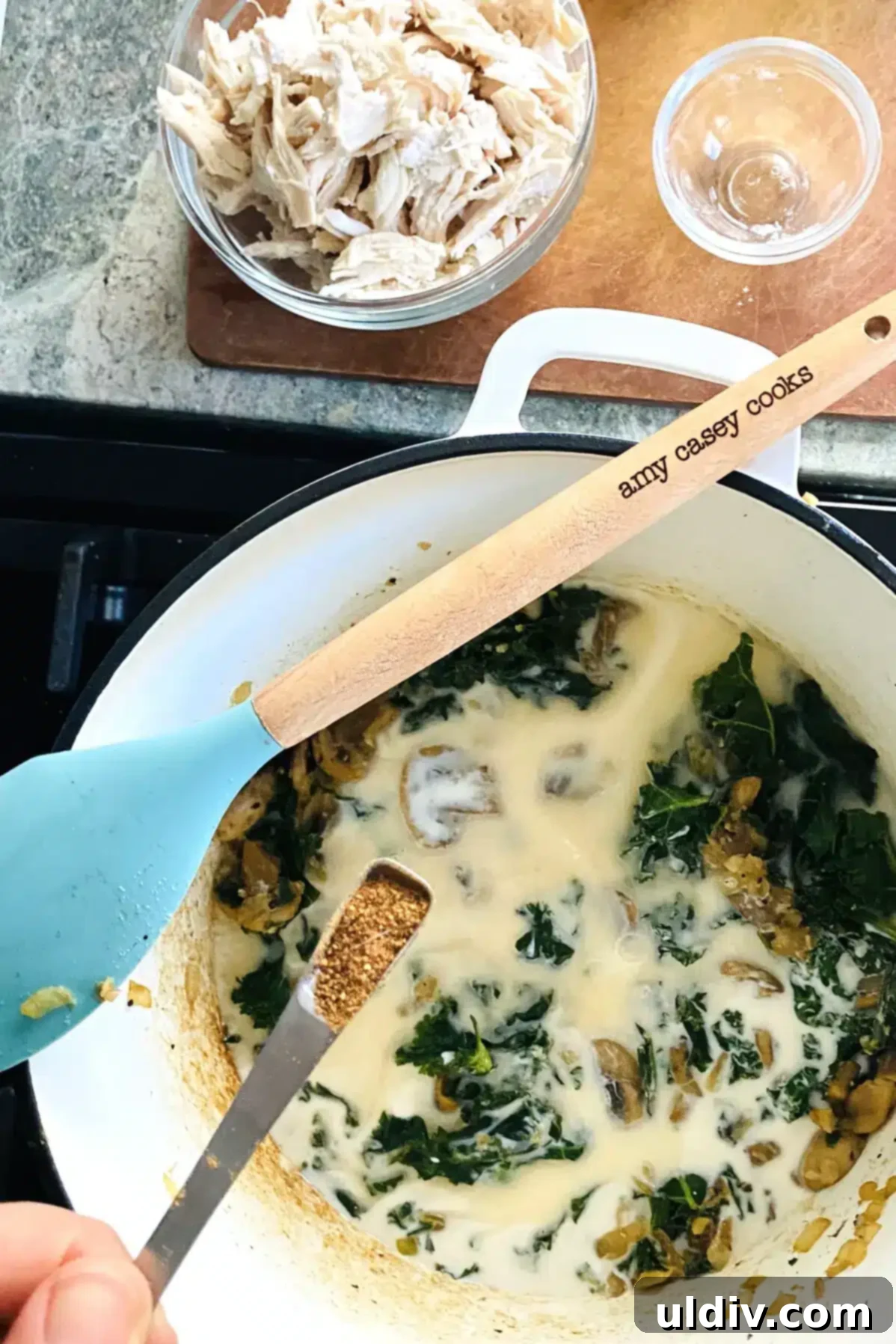 Hearty Creamy Chicken and Kale Bake 8 Adding light cream and chicken stock to the kale sauce mixture, with a small amount of nutmeg.