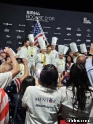 Bocuse d'Or 2025: What's Next? 6 A panoramic view of the bustling Sirha Lyon Expo floor, showcasing numerous booths, visitors, and culinary demonstrations.