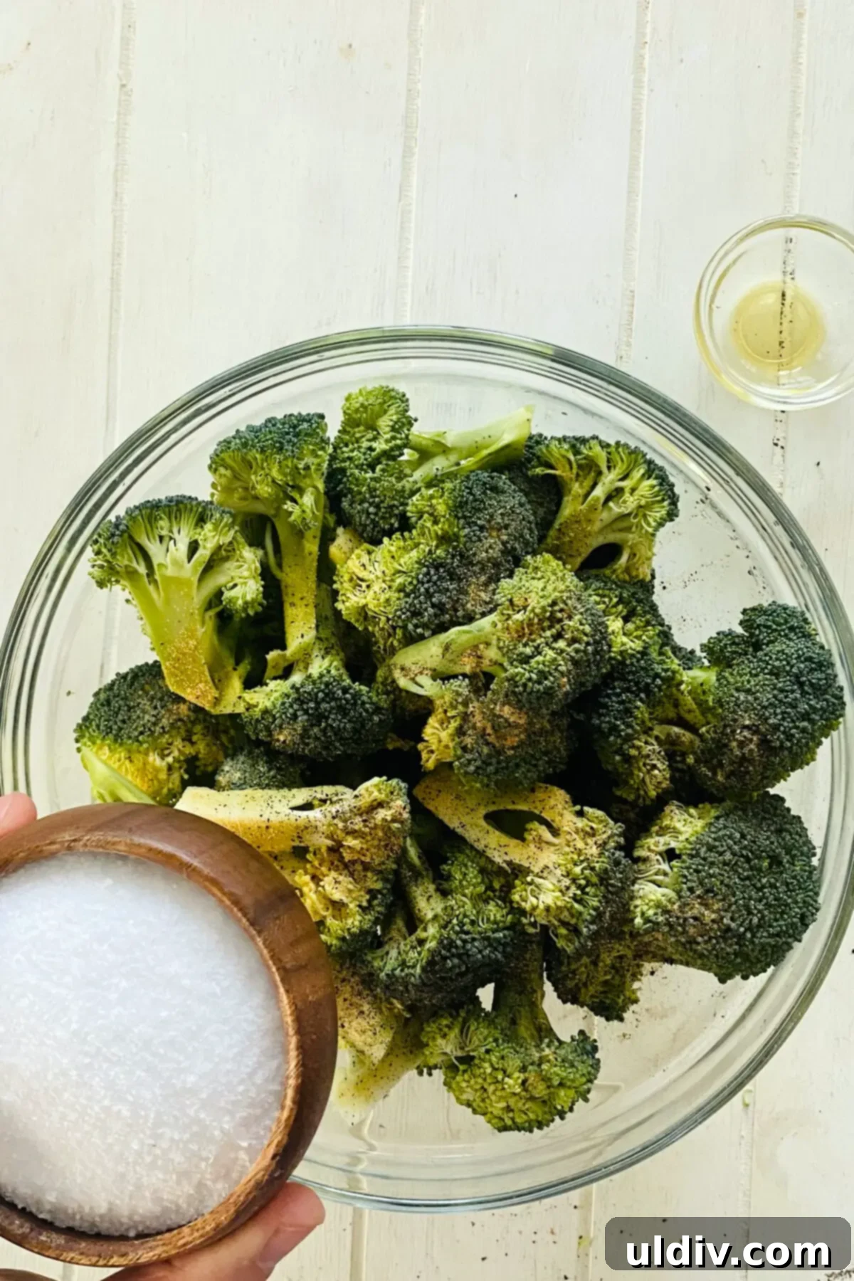 Golden Garlic Crispy Broccoli 8 adding kosher salt to raw broccoli.