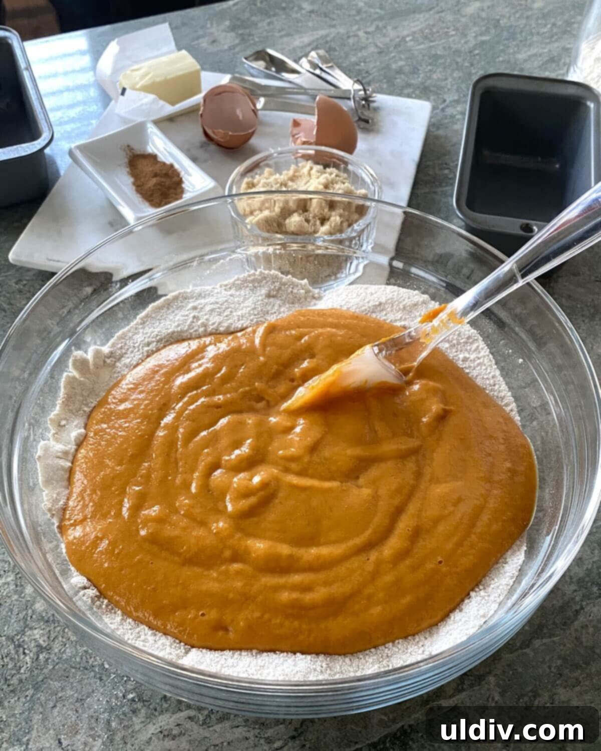 Delicious Mini Pumpkin Loaves 4 Wet ingredients for a pumpkin bread with streusel topping recipe are shown in a bowl.