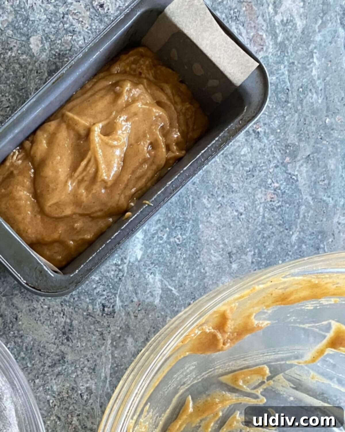 Delicious Mini Pumpkin Loaves 5 A mini loaf pan perfectly filled with pumpkin bread batter, ready for baking.