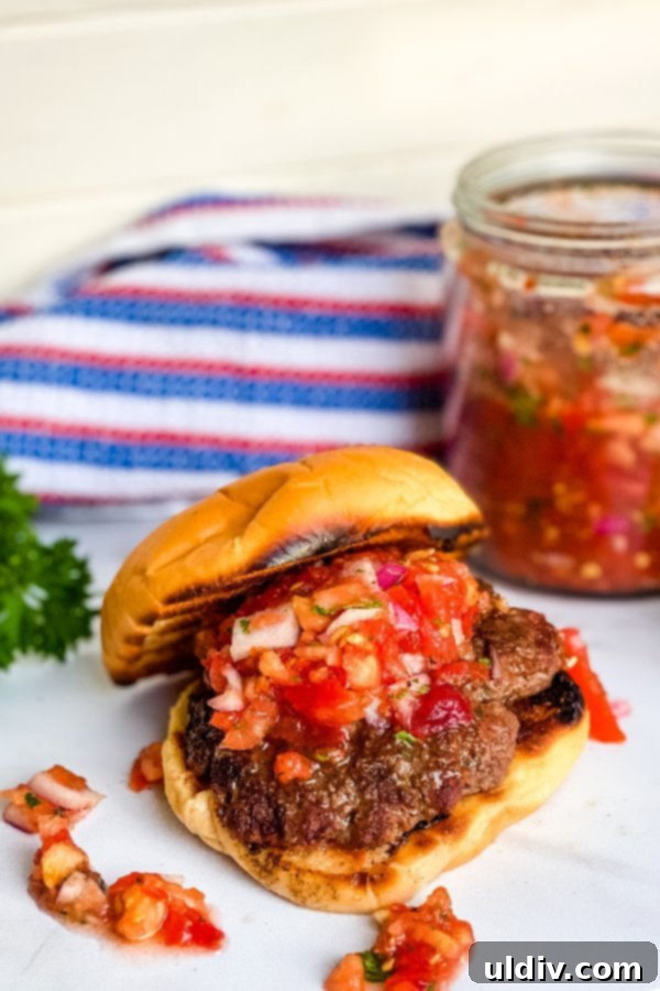 Garden Fresh Tomato Relish Burgers 2 Classic grilled beef burgers on toasted buns, generously topped with homemade fresh tomato relish, highlighting the vibrant colors and juicy texture.
