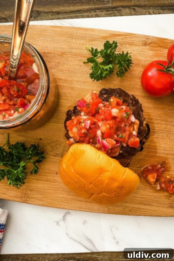 Garden Fresh Tomato Relish Burgers 4 Platter of perfectly grilled beef patties ready to be assembled with fresh tomato relish, showing their caramelized exterior.