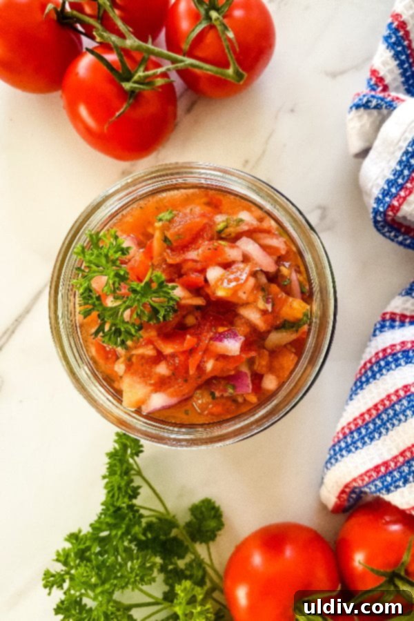Burgers with Zesty Tomato Relish 5 A bowl filled with freshly prepared homemade tomato relish, showcasing its vibrant colors and chunky texture, ready to be served.