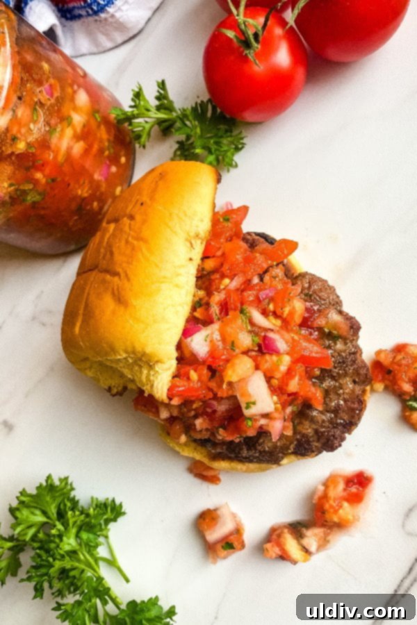 Garden Fresh Tomato Relish Burgers 8 Platter of several grilled burgers topped with tomato relish, ready for serving.