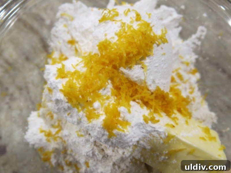 Lemon Zest Storage & Uses 3 Close-up of a lemon being zested with a microplane grater