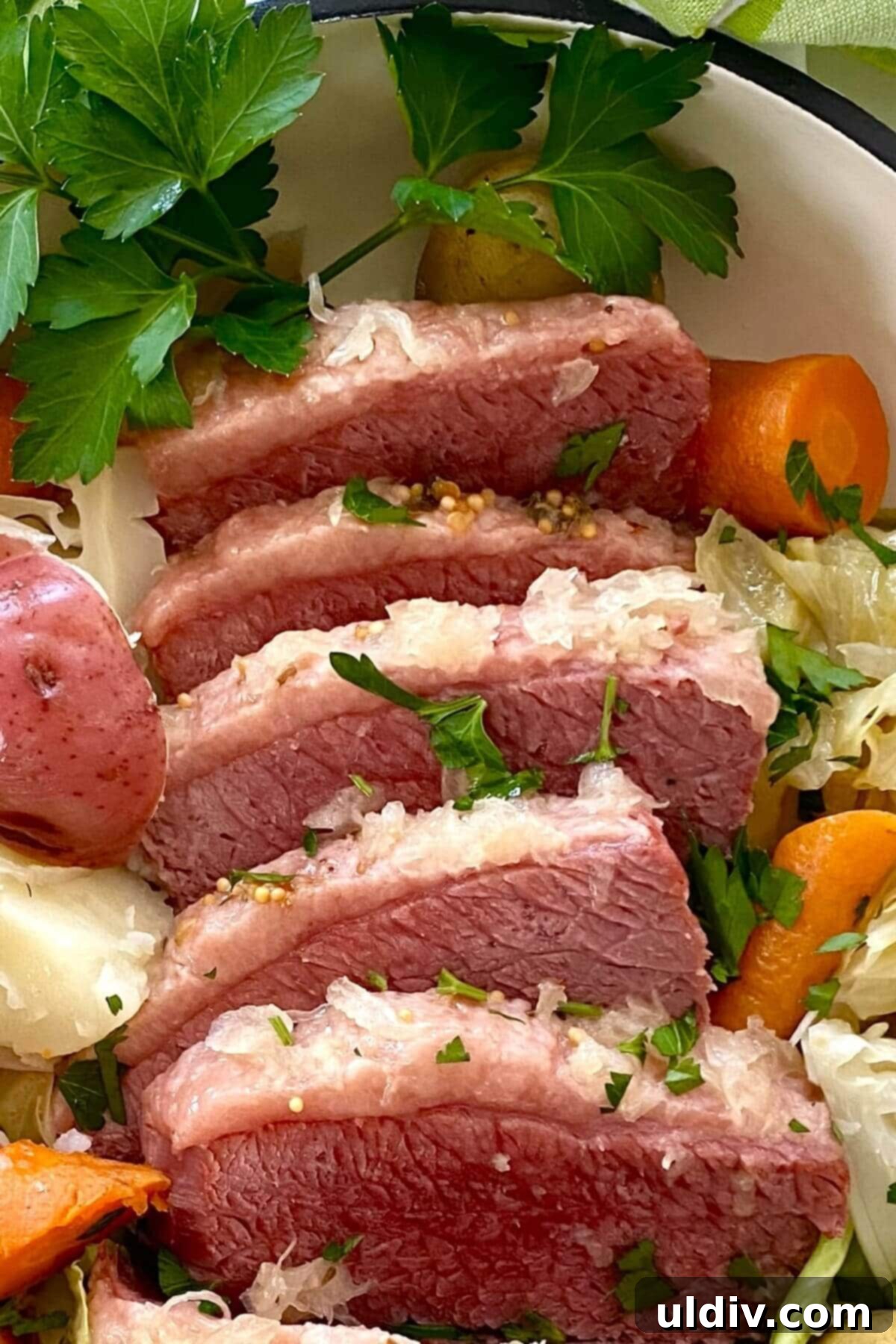 Perfectly Tender Instant Pot Corned Beef and Cabbage 3 5 slices of corned beef with carrots and cabbage.