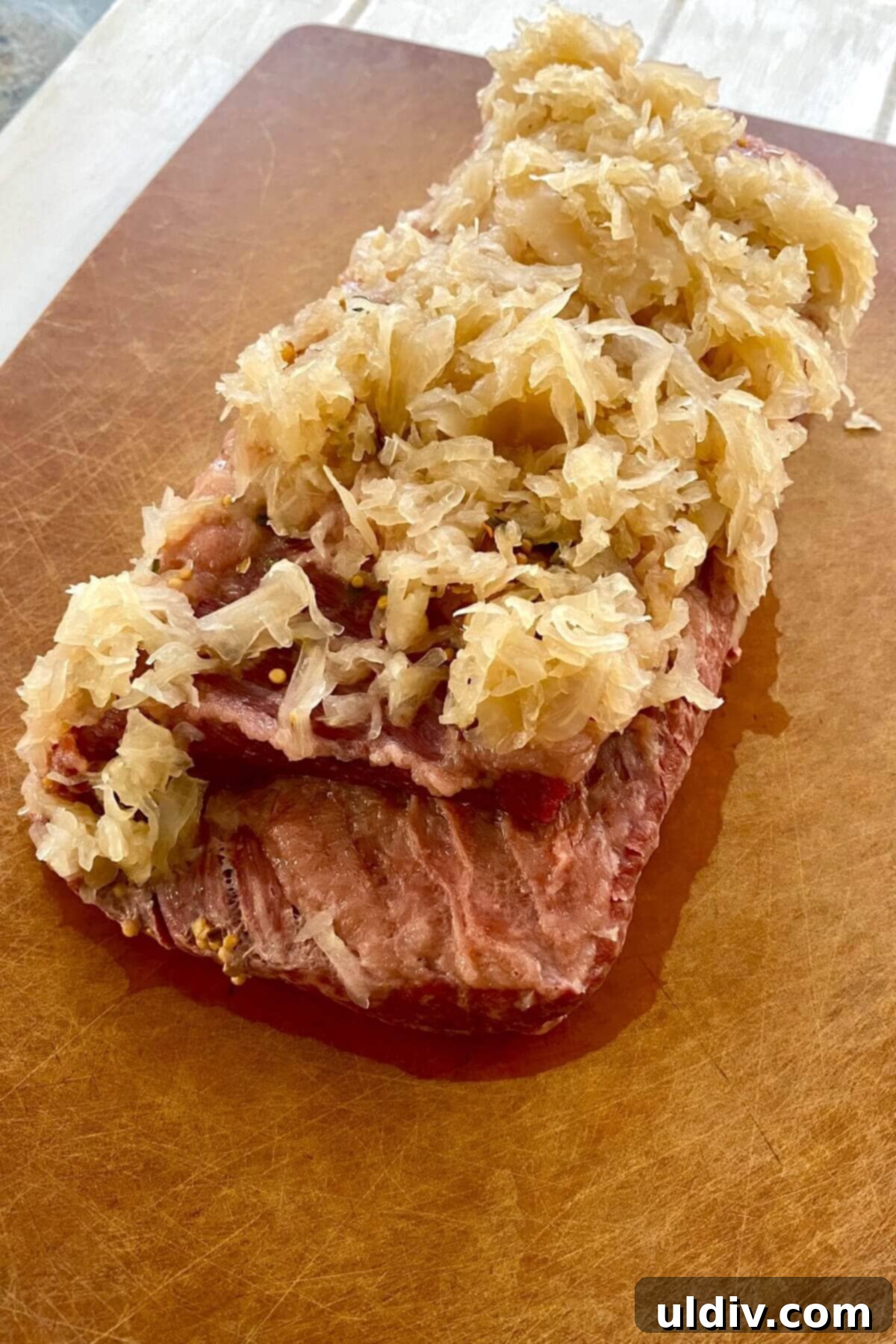 Perfectly Tender Instant Pot Corned Beef and Cabbage 7 Cooked corned beef on a cutting board.