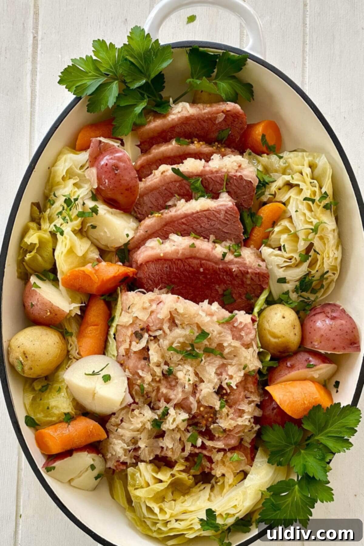 Perfect Instant Pot Corned Beef and Cabbage 10 A grand platter showcasing the complete Instant Pot corned beef meal, featuring sliced, tender corned beef surrounded by soft cabbage, colorful carrots, and hearty potatoes, garnished with fresh parsley.