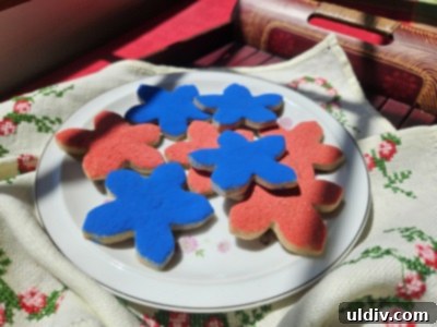 Patriotic Memorial Day Cookies 2 Delicious Ann Clark forget-me-not sugar cookies decorated for Memorial Day, arranged on a plate with fresh flowers.
