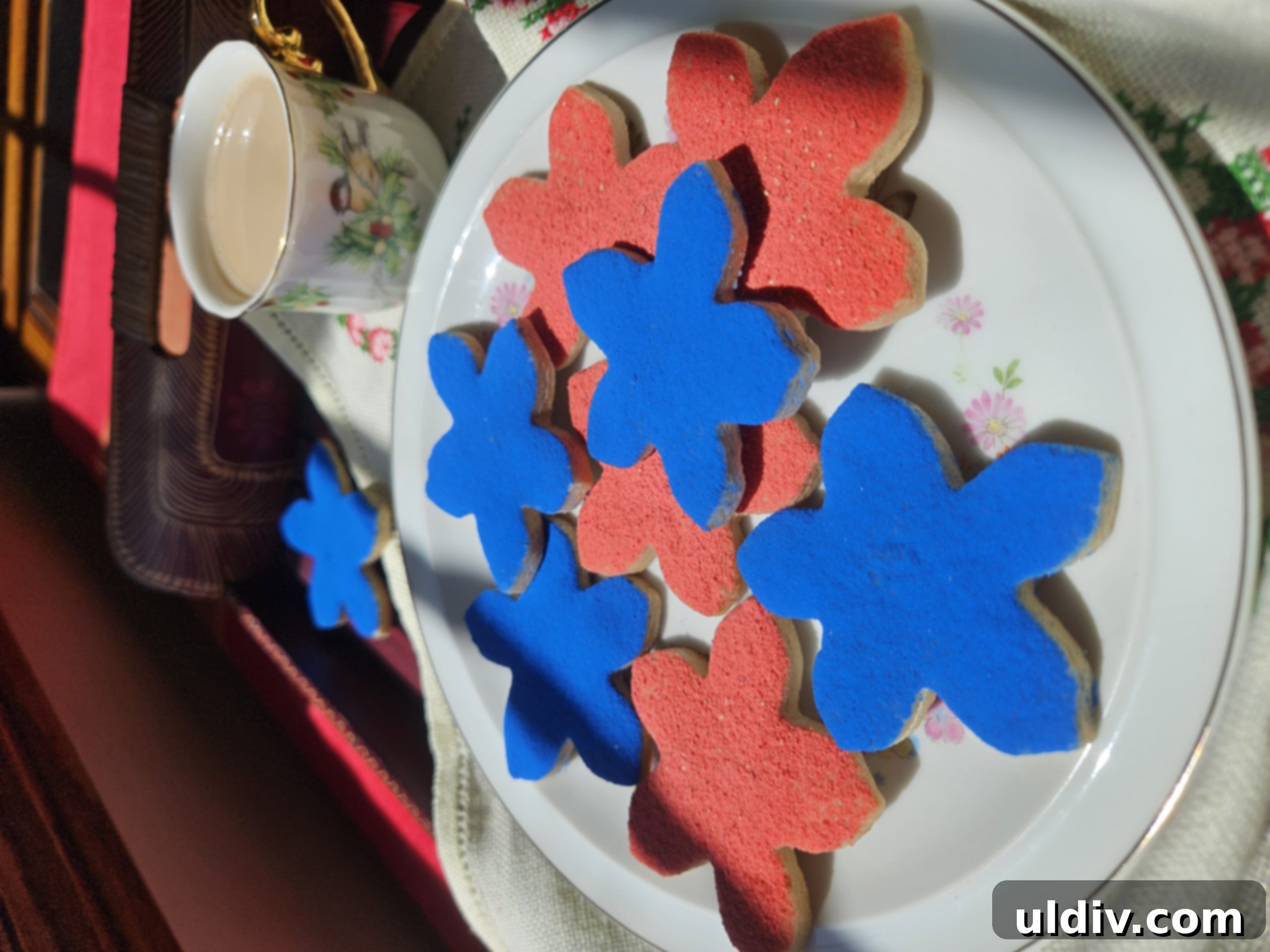 Patriotic Memorial Day Cookies 3 Close-up of freshly baked Ann Clark forget-me-not sugar cookies, delicately decorated with natural pink and green sprinkles, embodying spring and remembrance.