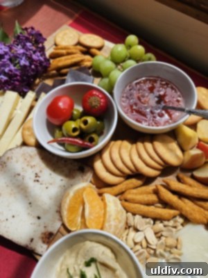 Savoring Cheese Month: Storage Secrets Revealed 8 A close-up of a selection of artisan cheeses, including Mobay, Fontina de Provence, and Cocoa Cardona, on a wooden board.