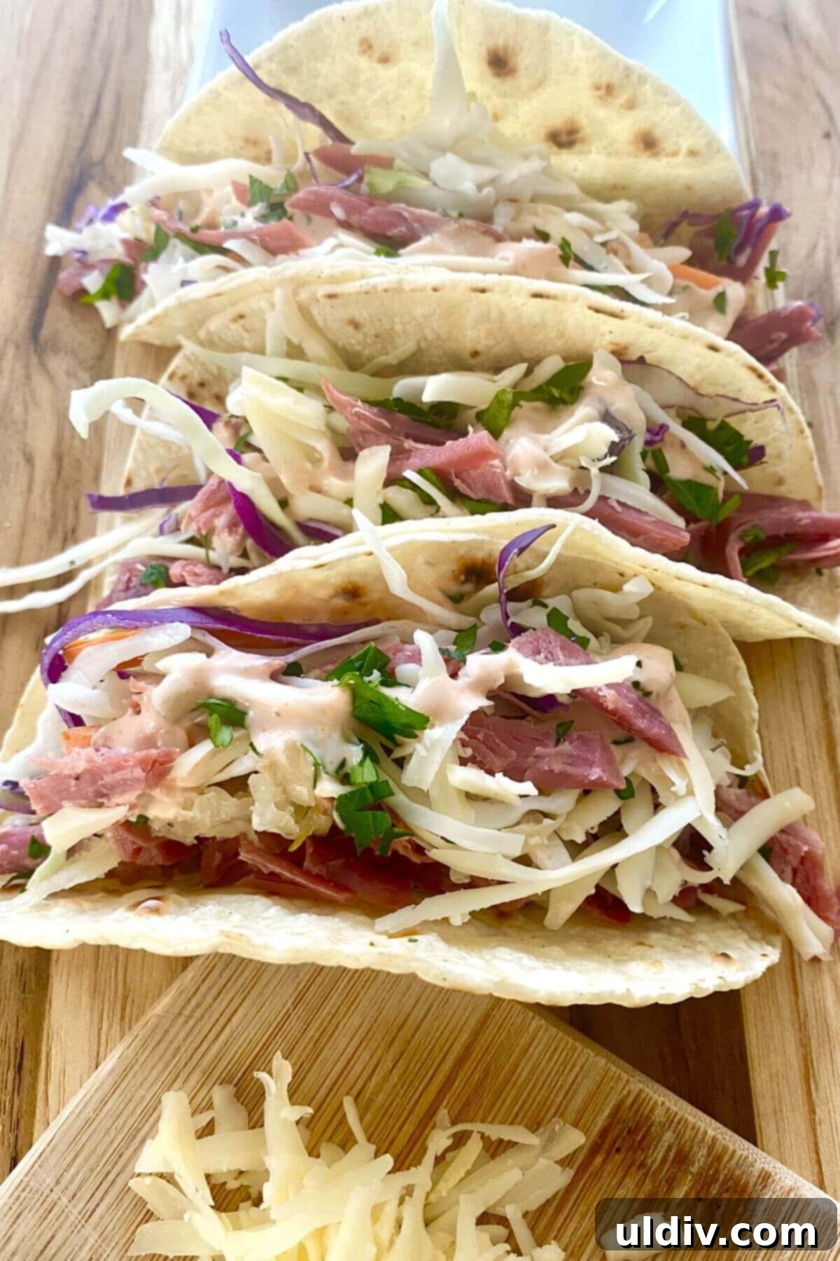 Irish Tacos: The Corned Beef & Cabbage Twist 2 Irish tacos recipe with filled corn tortillas, showcasing the layers of corned beef, sauerkraut, cabbage slaw, and cheese.