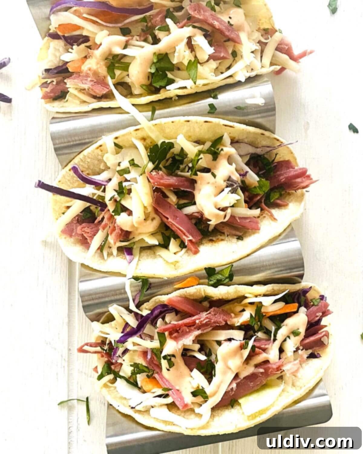 Irish Corned Beef and Cabbage Tacos 8 Two Irish tacos filled with corned beef, cabbage, and cheese, neatly arranged in a taco holder.